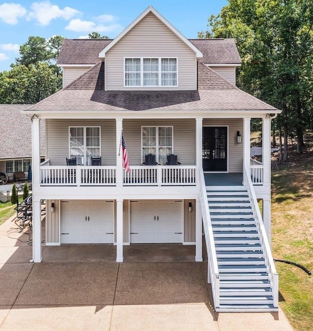 view of front of house with a garage, french doors, and covered porch