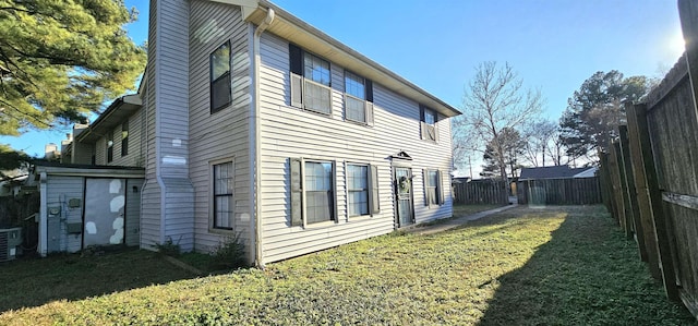 view of property exterior with central AC unit and a lawn