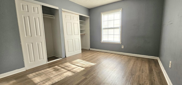 unfurnished bedroom featuring wood-type flooring and a textured ceiling