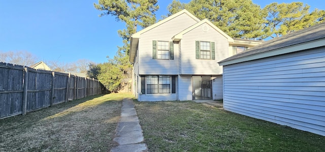 rear view of house featuring a lawn