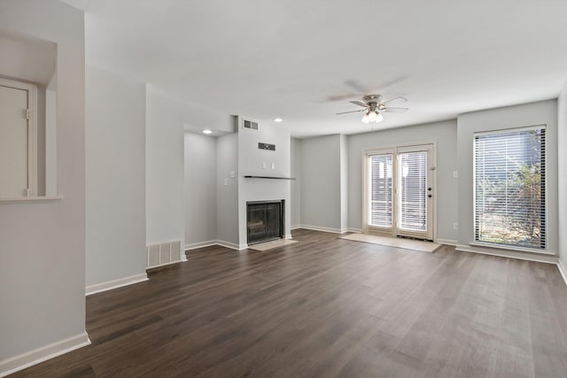 unfurnished living room featuring dark hardwood / wood-style floors and ceiling fan