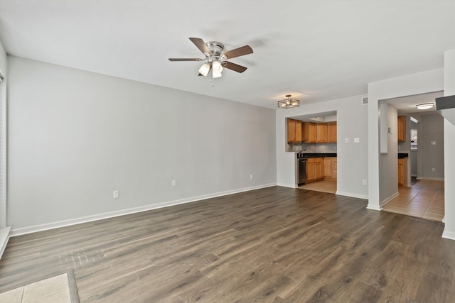 unfurnished living room featuring dark hardwood / wood-style floors and ceiling fan