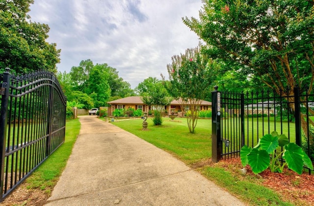 view of gate with a yard