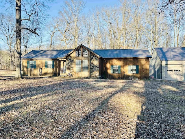 ranch-style house featuring a garage and an outdoor structure