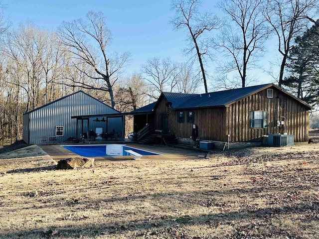 rear view of house featuring a patio and central AC