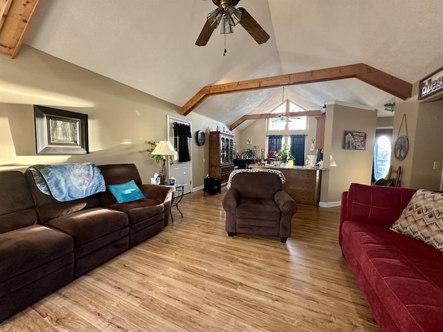 living room with ceiling fan, vaulted ceiling with beams, and light hardwood / wood-style floors