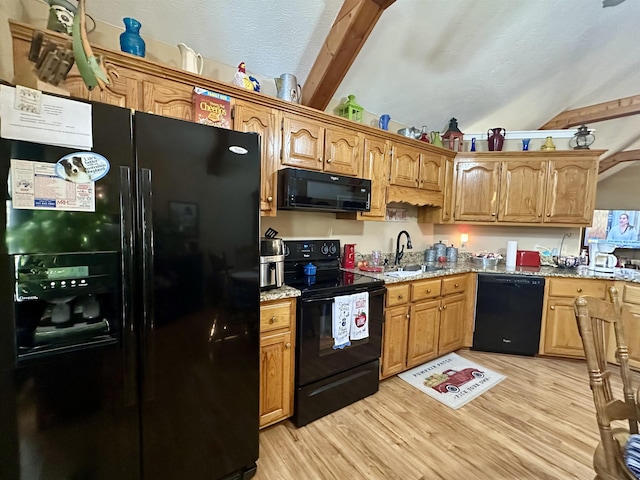 kitchen featuring lofted ceiling with beams, sink, light hardwood / wood-style floors, and black appliances