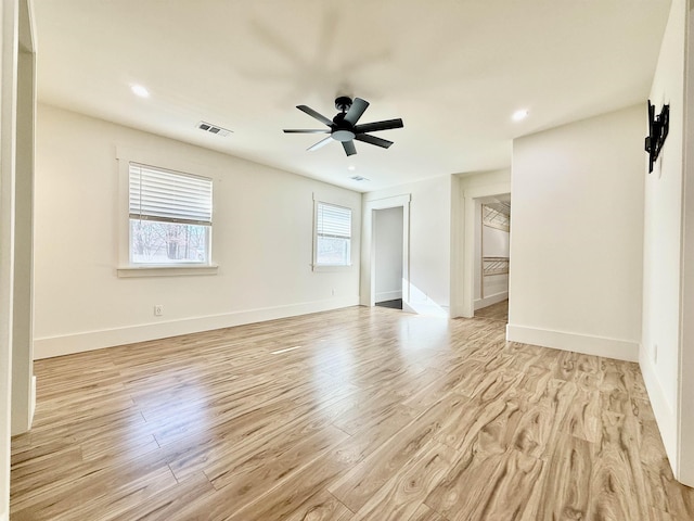 empty room with ceiling fan and light wood-type flooring