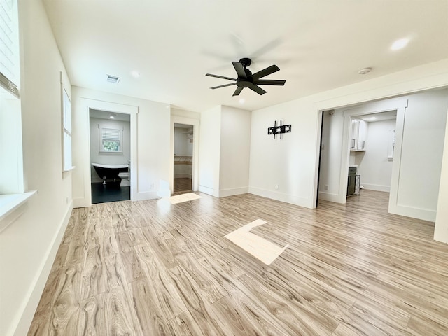 unfurnished living room featuring ceiling fan and light hardwood / wood-style flooring