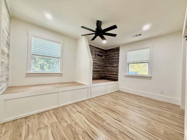 unfurnished room with ceiling fan and light wood-type flooring