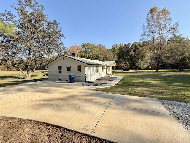 view of side of home with a lawn