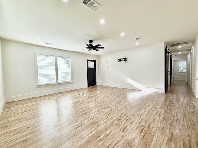 interior space with ceiling fan and light hardwood / wood-style flooring