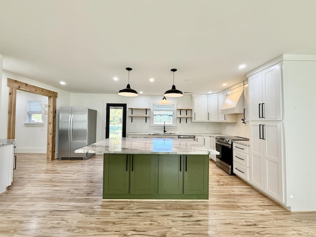 kitchen featuring sink, stainless steel appliances, a center island, light stone counters, and white cabinets