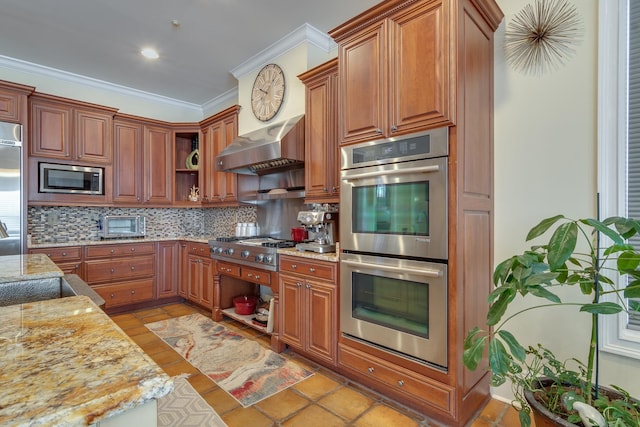 kitchen featuring backsplash, stainless steel appliances, crown molding, light stone countertops, and wall chimney exhaust hood