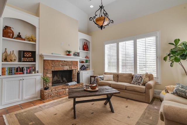 living room featuring built in shelves, a fireplace, light tile patterned flooring, and vaulted ceiling