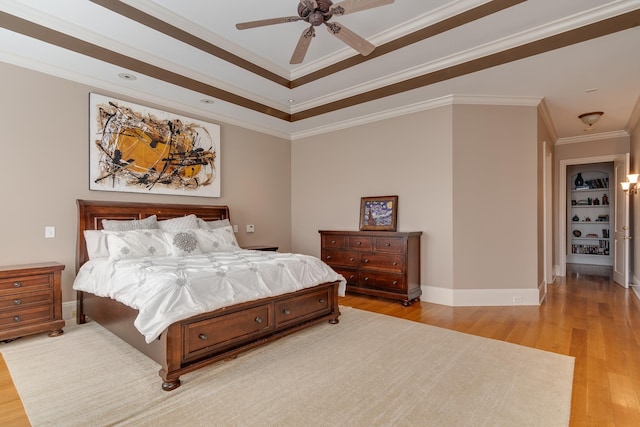 bedroom with crown molding, light hardwood / wood-style flooring, and ceiling fan