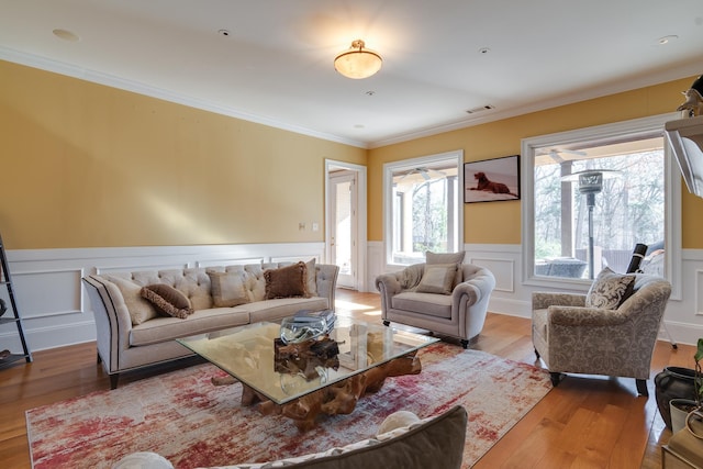 living room featuring crown molding and light wood-type flooring