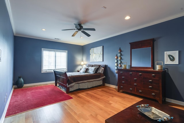 bedroom with crown molding, hardwood / wood-style flooring, and ceiling fan