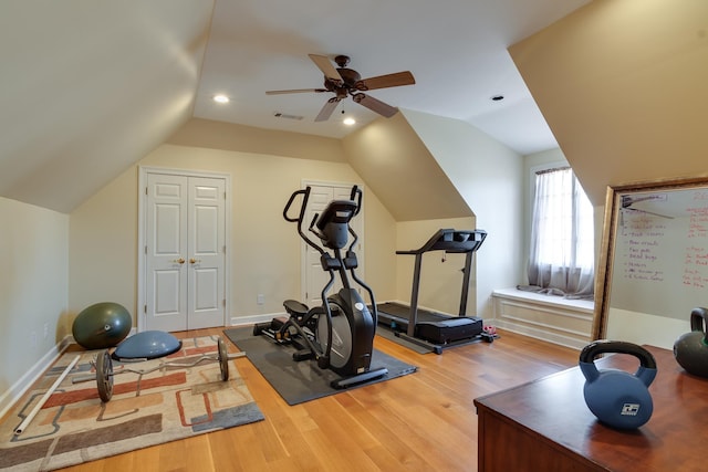 exercise room featuring vaulted ceiling, ceiling fan, and hardwood / wood-style floors