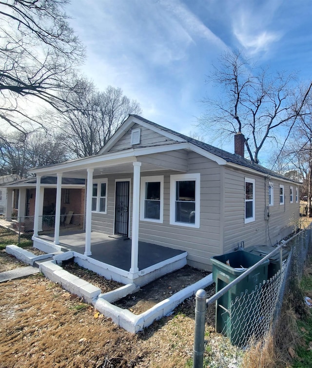 back of property with a porch