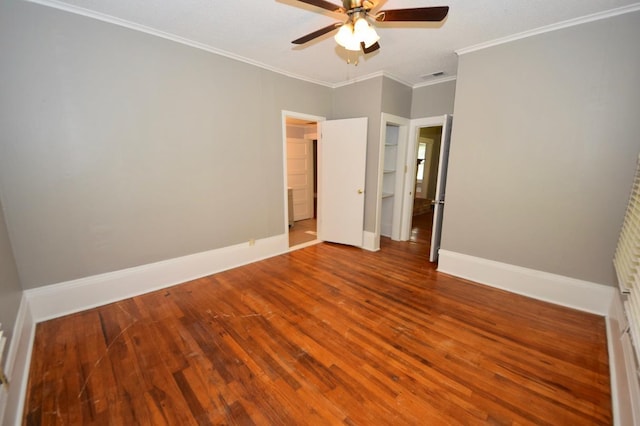 unfurnished bedroom featuring wood-type flooring, ornamental molding, and ceiling fan