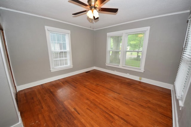 unfurnished room featuring ceiling fan, ornamental molding, wood-type flooring, and a textured ceiling