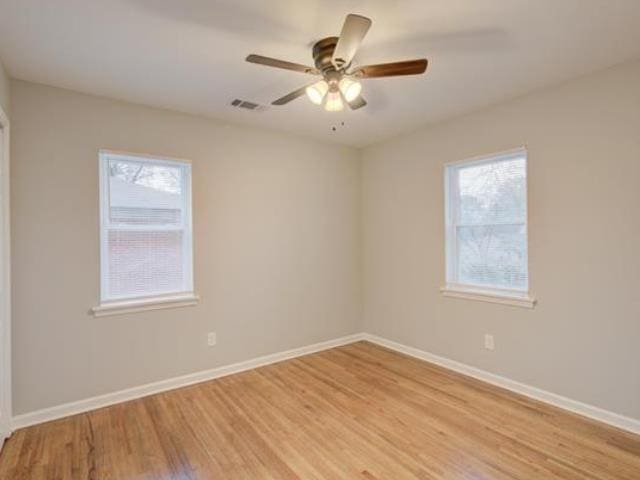 empty room featuring ceiling fan and light hardwood / wood-style floors