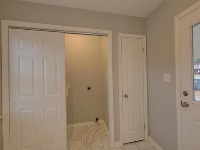 washroom with hookup for an electric dryer