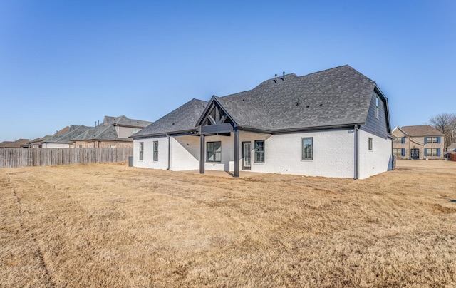 rear view of property with a yard