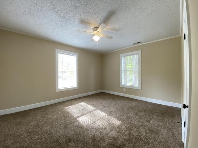 carpeted spare room featuring a textured ceiling, ornamental molding, and ceiling fan