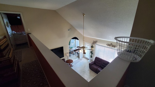 living room featuring ceiling fan and high vaulted ceiling