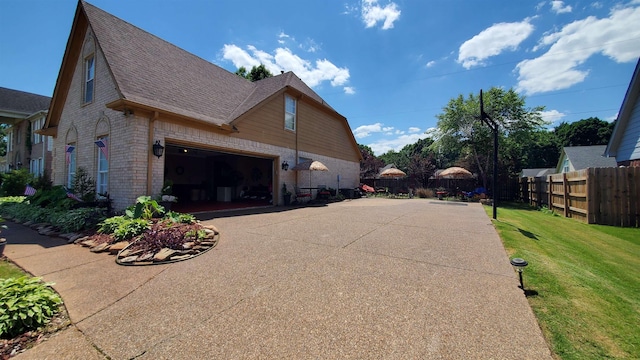 view of side of home with a garage and a yard