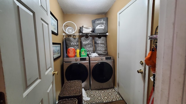 washroom featuring washer and dryer and a textured ceiling