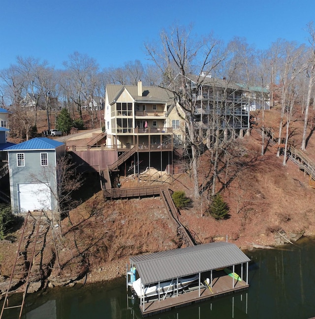 rear view of property with a water view