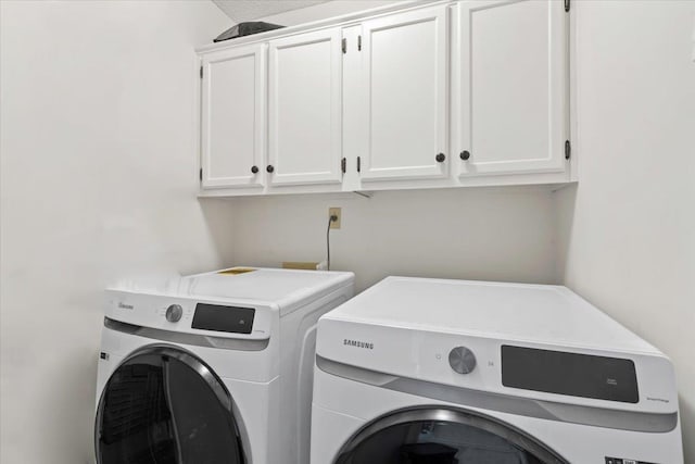 washroom with cabinets and separate washer and dryer