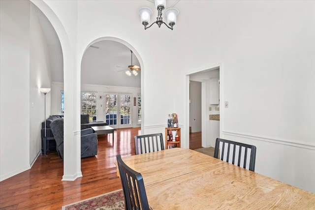 dining room featuring dark hardwood / wood-style flooring and ceiling fan with notable chandelier