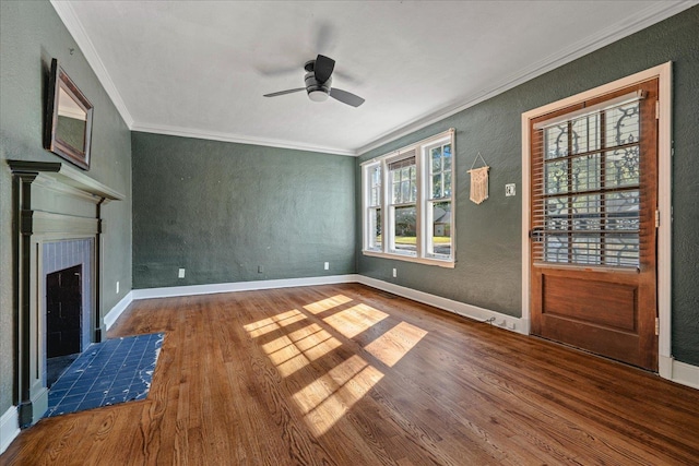 unfurnished living room with crown molding, ceiling fan, a fireplace, and hardwood / wood-style flooring