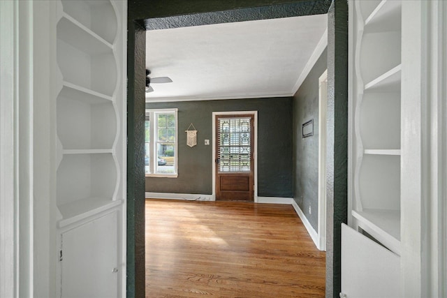 entrance foyer featuring hardwood / wood-style floors and ornamental molding