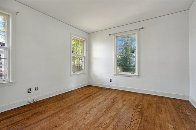 spare room with hardwood / wood-style flooring