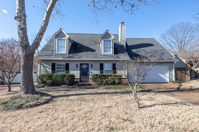 cape cod home with a garage and a front lawn