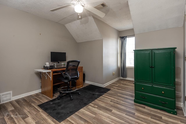 home office featuring wood-type flooring, lofted ceiling, ceiling fan, and a textured ceiling