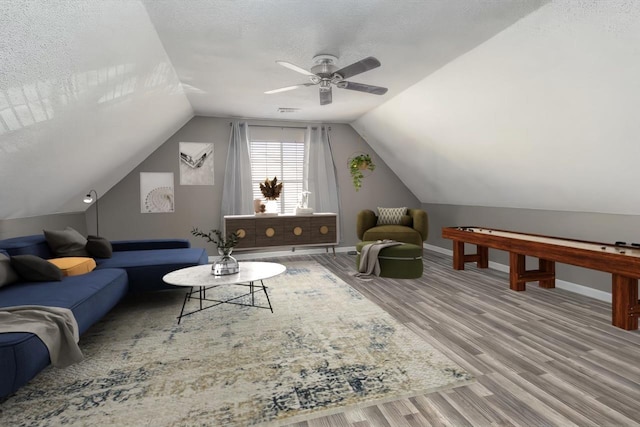 interior space with lofted ceiling, hardwood / wood-style floors, a textured ceiling, and ceiling fan