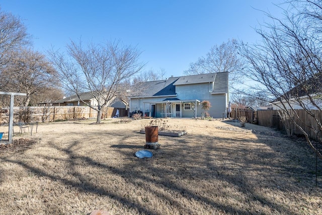 rear view of house with a yard