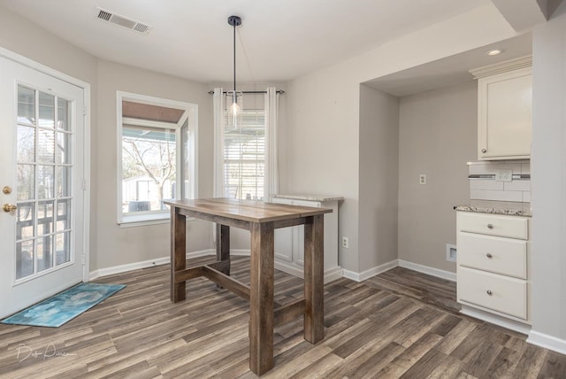 dining space featuring dark hardwood / wood-style floors