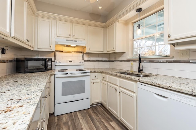 kitchen with sink, white appliances, dark wood-type flooring, hanging light fixtures, and backsplash