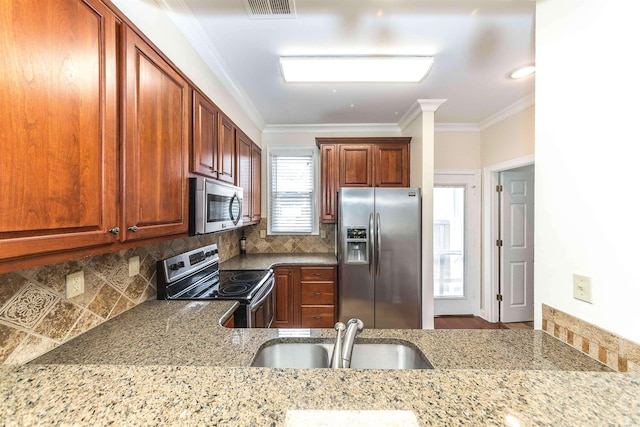 kitchen featuring tasteful backsplash, sink, crown molding, and appliances with stainless steel finishes