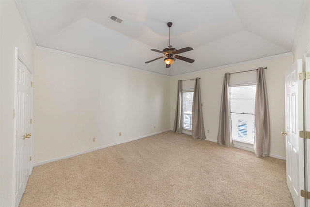 carpeted empty room with a tray ceiling, ornamental molding, and ceiling fan