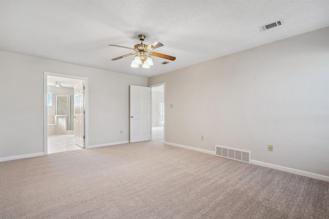 carpeted spare room featuring a textured ceiling and ceiling fan