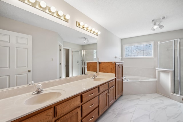 bathroom with vanity, plus walk in shower, and a textured ceiling