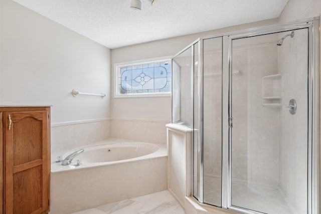 bathroom with shower with separate bathtub and a textured ceiling